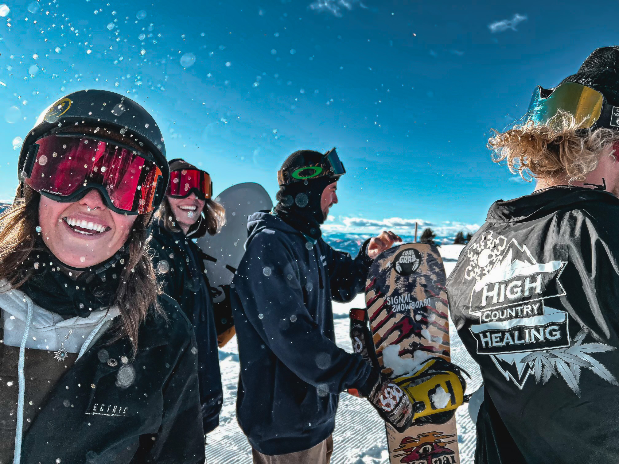 Group of High Country Healing Vail Employees on top of the moutain with snowboard equipment